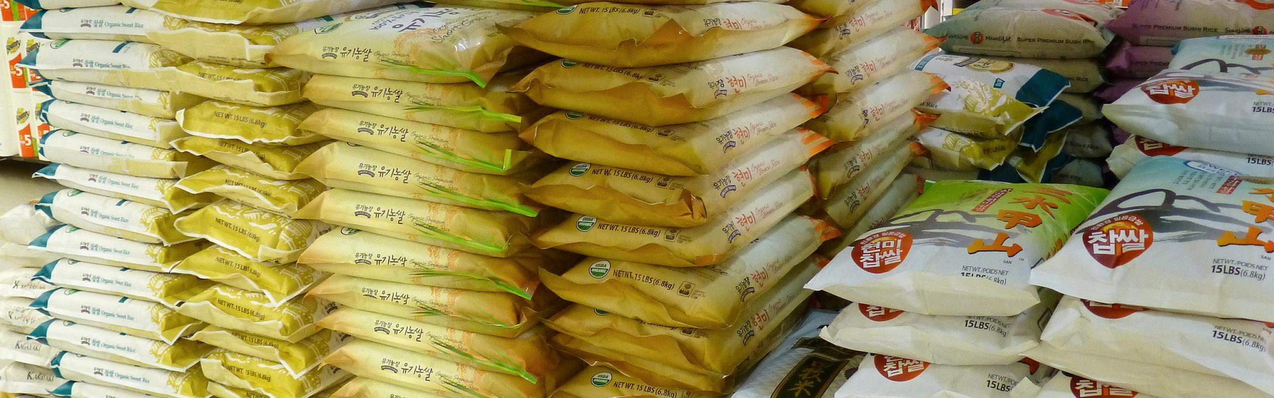 Piles of bags of rice in supermarket