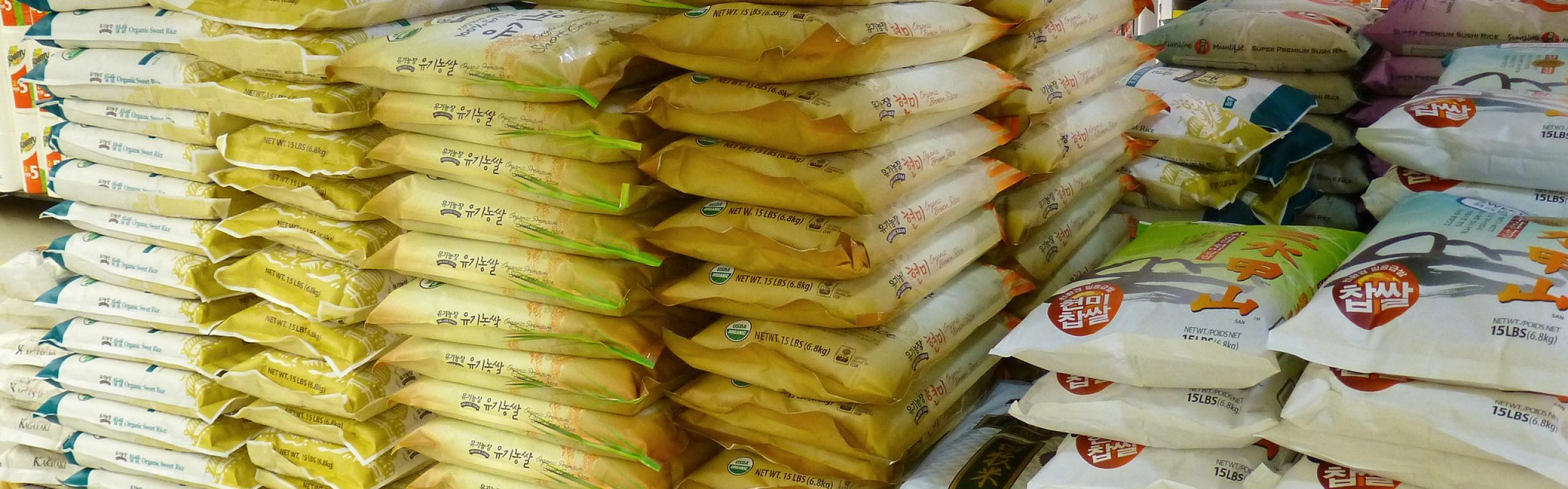 Piles of bags of rice in supermarket