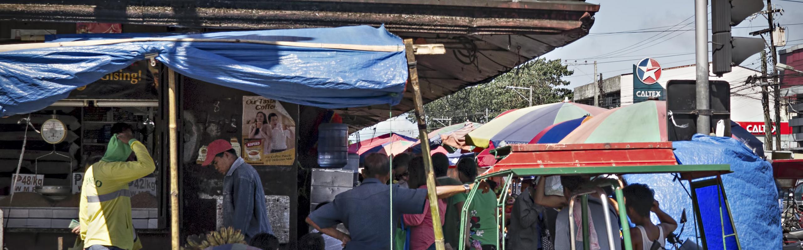 Rice and corn dealer outside Burgos street market Bacolod City, Philippines