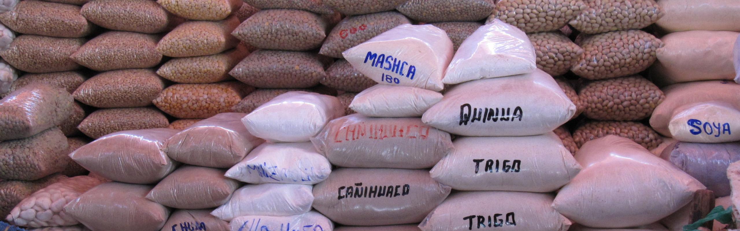 Bags of grain piled in a market in Peru
