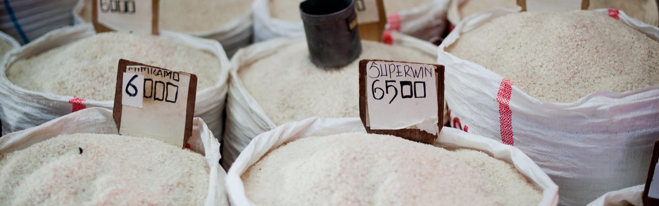 A vendor in Bitung's Aertembaga Market displays bags of rice for sale.