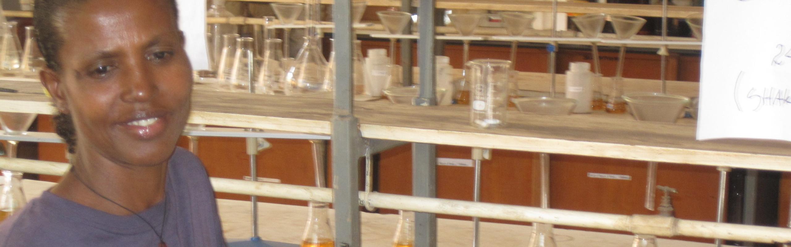 Laboratory technician in a blue t-shirt at the Soils lab at Hawassa University College of Agriculture, shaking bones with coffee wastewater