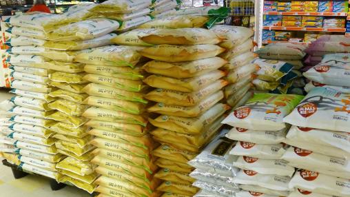 Piles of bags of rice in supermarket
