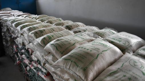  Bags of rice, wheat flour, and sugar stacked in warehouse in Uganda.
