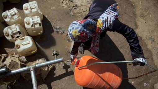 omen filling a Water Roller in a water point in Sudanese camp for internal displaced people. Conflict and extreme weather shocks continued to drive acute food insecurity in 2021.