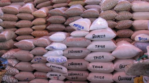 Bags of grain piled in a market in Peru
