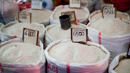 A vendor in Bitung's Aertembaga Market displays bags of rice for sale.