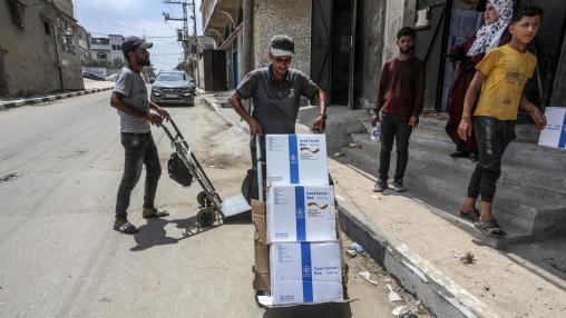 The World Food Program begins distributing German aid to the displaced and local residents in Deir al-Balah in the central Gaza Strip, on June 9, 2024.